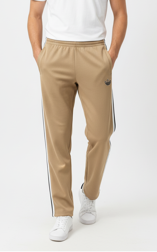 Man wearing a white t-shirt and beige pants with a side stripe on a white background