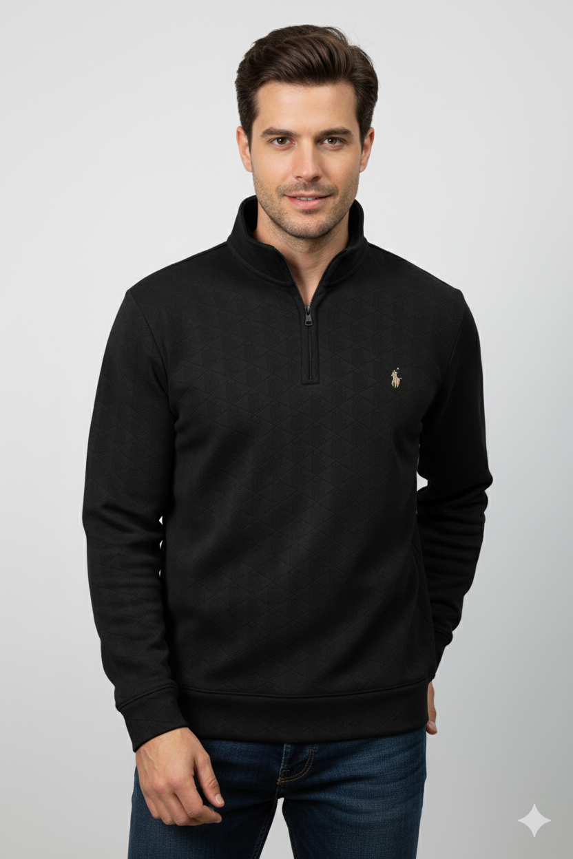 Man wearing a black pullover with a brand logo on a light gray background