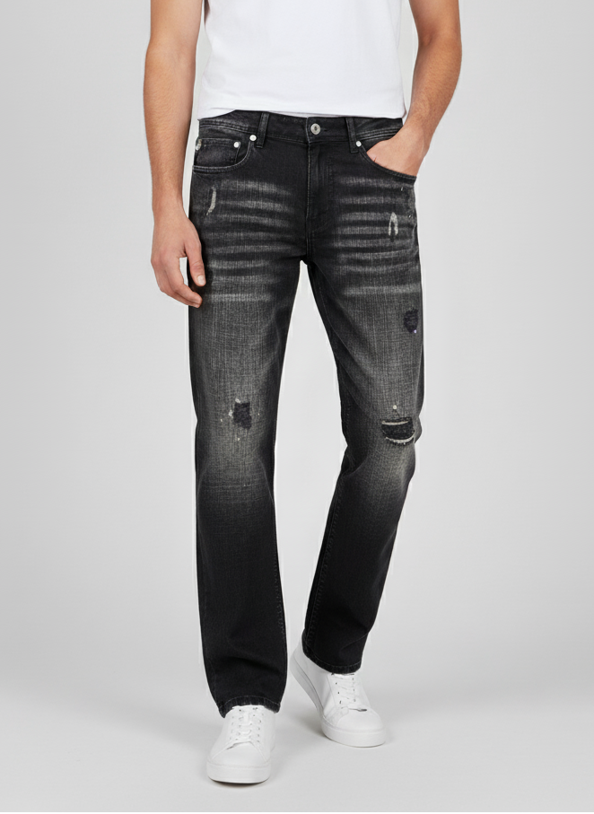 Person wearing black distressed jeans and a white t-shirt on a light gray background