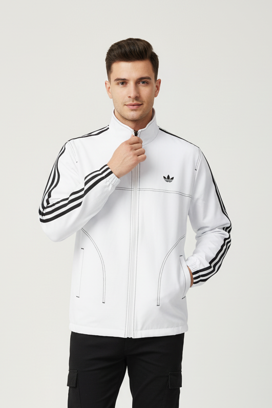 Man wearing a white Adidas tracksuit with black pants on a white background