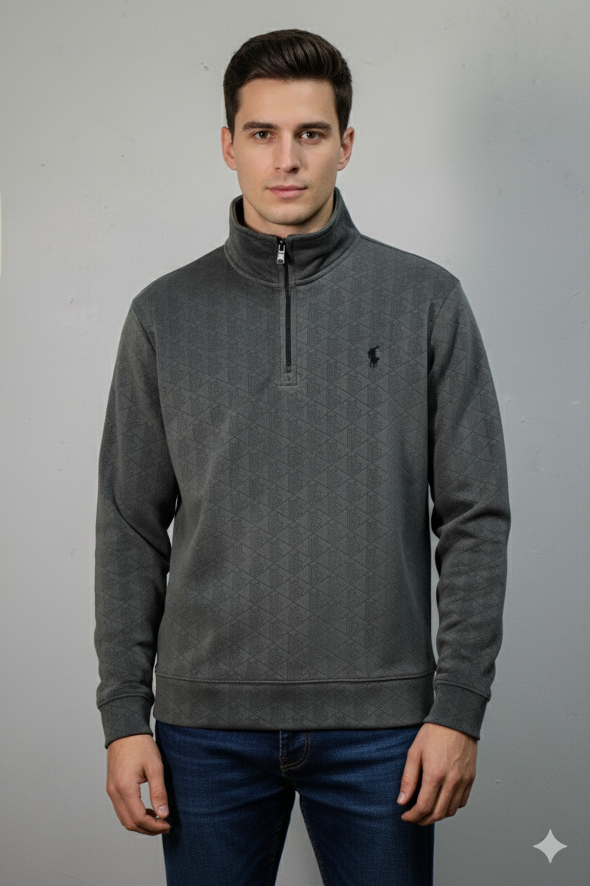 Man wearing a gray half-zip sweatshirt against a gray background