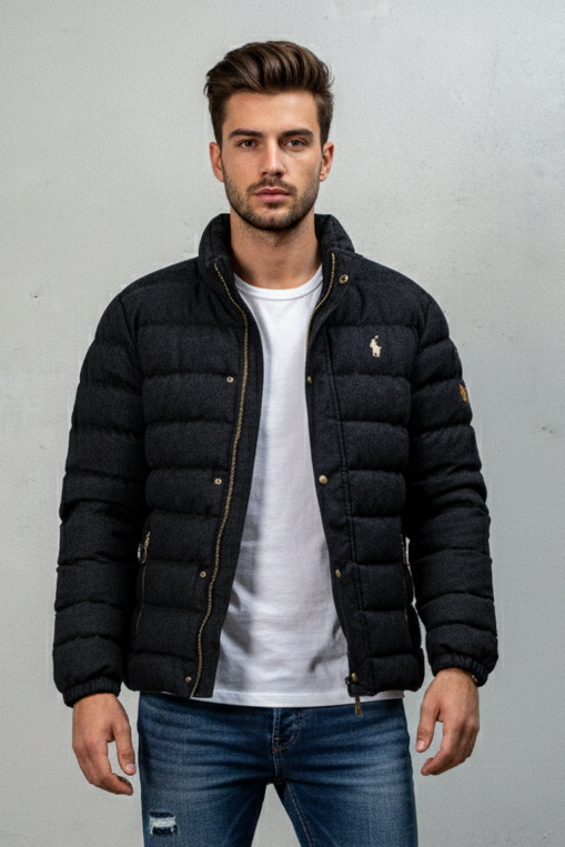 Man wearing a black puffer jacket over a white shirt with a gray background