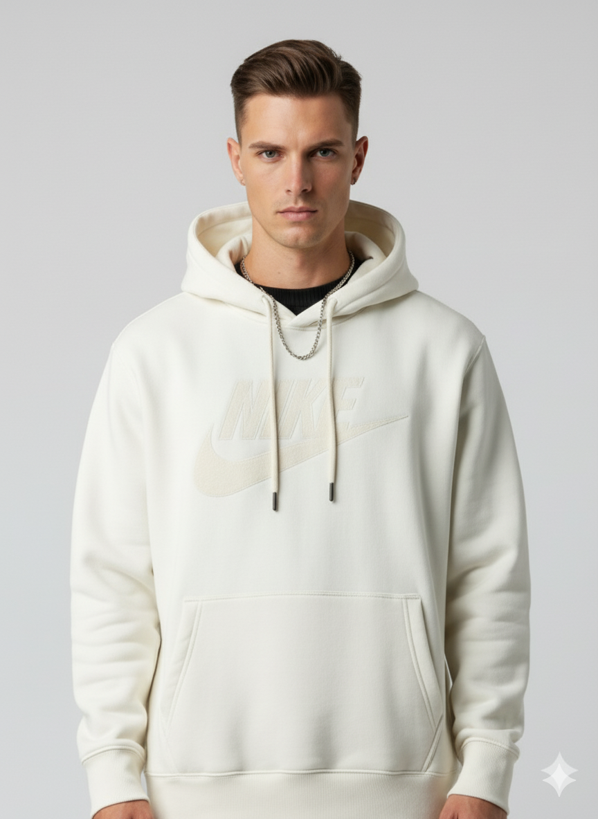 Man wearing a beige hoodie against a plain background