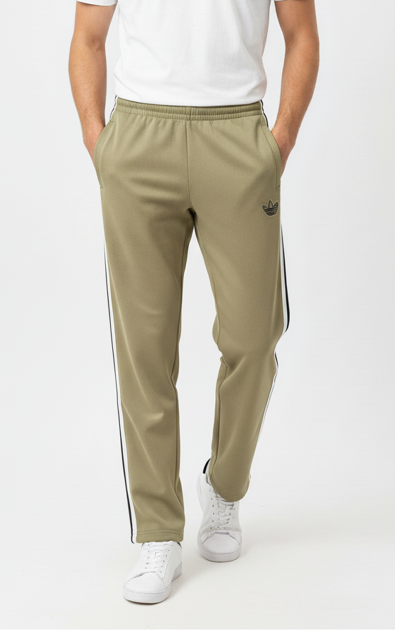 Man wearing a white t-shirt and beige track pants with white stripes on a white background