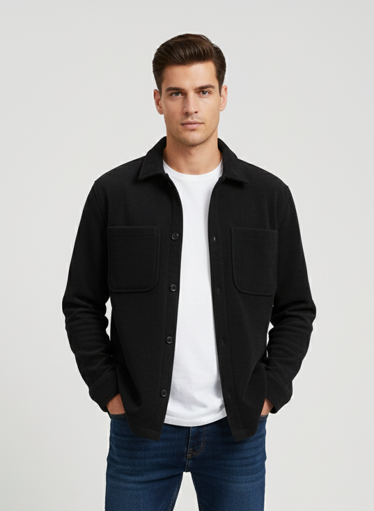 Man wearing a black shacket, white shirt and blue jeans on a white background